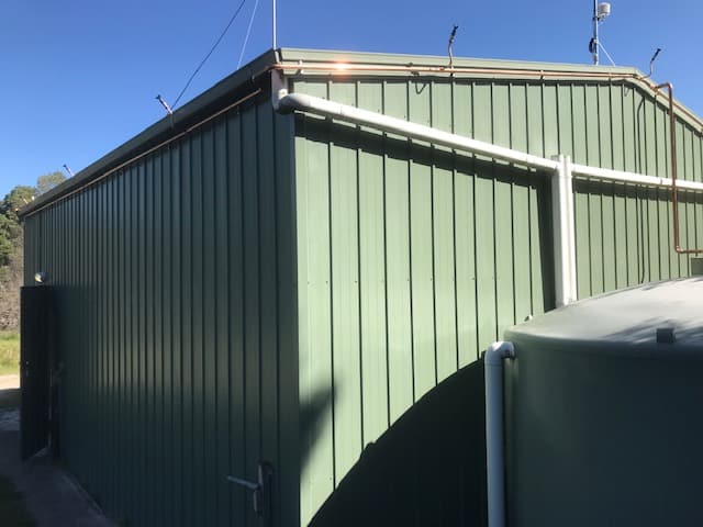 Bush fire sprinkler system protecting shed